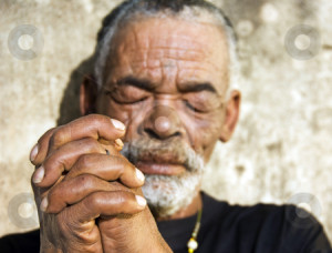 An old African man with folded hands - focus on the weathered hands